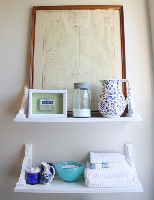 vintage inspired diy shelves, bathroom ideas, shelving ideas, After attaching the shelves to the wall using drywall anchors I was able to amp up the vintage charm by layering in pieces from my collection not all of them old