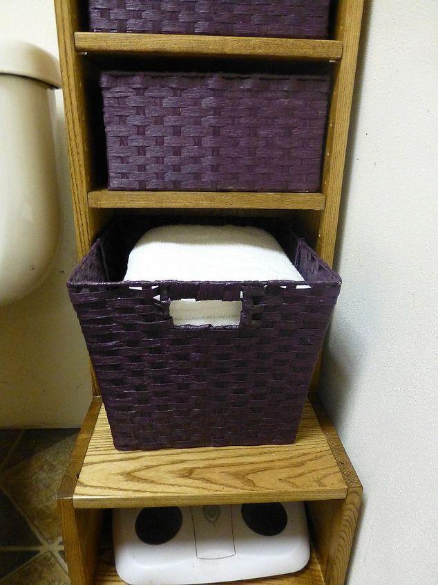 tiny bathroom storage, bathroom ideas, shelving ideas, storage ideas, I bought the eight smaller baskets in purple and couldn t bear to see this one larger basket there by itself It turned out to be the perfect size for towels The bathroom scale tucks nicely under this shelf