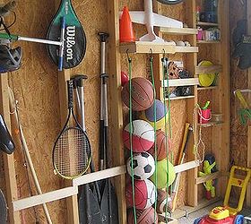 garage storage, cleaning tips, doors, garages, shelving ideas, storage ideas, Nailing slats to the studs provided space to store oars fishing poles baseball bats For balls we nailed a U shape top bottom drilled holes attached bungee cords into the holes
