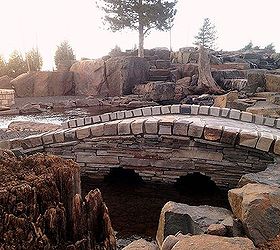 pond bridge, decks, outdoor living, ponds water features, A nice touch to this project that utilized 500 000 pounds of stone to build a pond wetland filter waterfalls fire pit pavilion and stone steps to a remote seating viewing area under the pine beside the cascading water