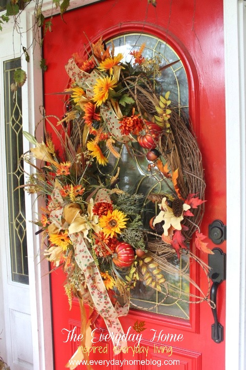 a southern fall front porch, doors, porches, seasonal holiday decor, wreaths, A large wreath with oranges and reds and Fall colors makes a statement It says I m HERE