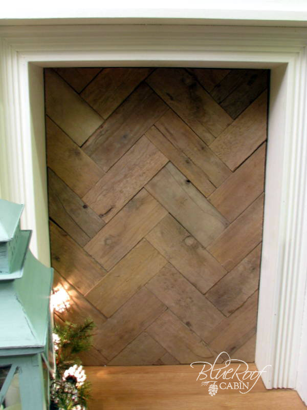 faux fireplace pallet wood fire box, fireplaces mantels, home decor, pallet wood laid in a herringbone pattern