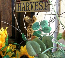 a simply beautiful fall porch, porches, seasonal holiday decor, I added this harvest sign and some sticks from the yard to give the sunflowers a Fall touch