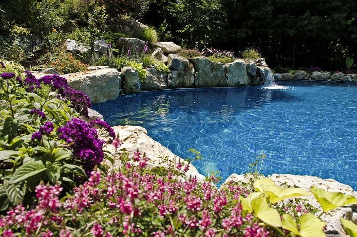 can retaining walls be beautiful as well as functional, gardening, landscape, outdoor living, ponds water features, pool designs, Beautiful Retaining Wall Bright huge bursts of colored plantings moss rock and boulders from Pennsylvania as well as pool s edge firmly hold back slope