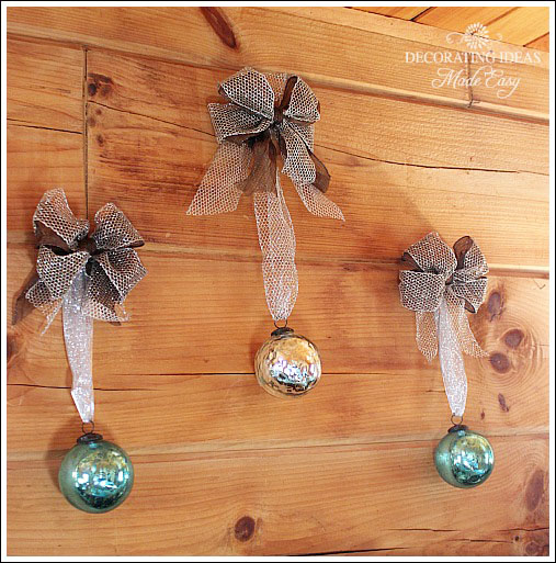 i ll have a blue christmas, crafts, seasonal holiday decor, Hanging three glass balls with ribbon above the bed made for a very cheap Christmas decorating idea