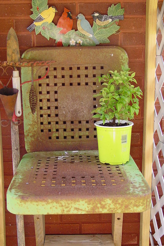 a stroll to my potting area with camera in hand, gardening, outdoor living, repurposing upcycling, I spotted this old metal yard chair in a nearby neighborhood It was on a porch that was obviously never used for sitting just storing things It was free for the asking