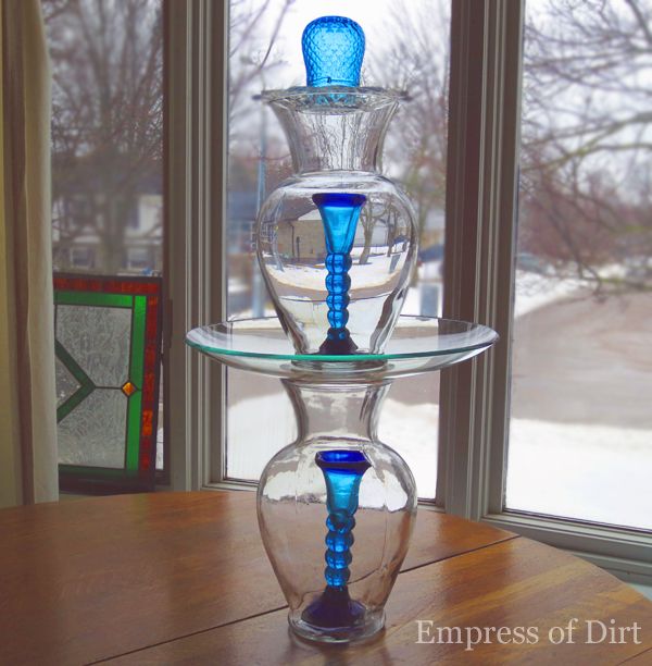 From the bottom up, I used a vase (with a candle stick in it), a wide plate, another vase (with a candle stick), a small plate, and an upside-down votive candle holder.