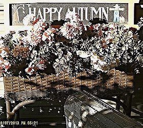 fall decorating at the small house under a big sky d cor roundup, flowers, gardening, seasonal holiday d cor, Flowers and a fall sign decorate the wicker fernery on the studio porch
