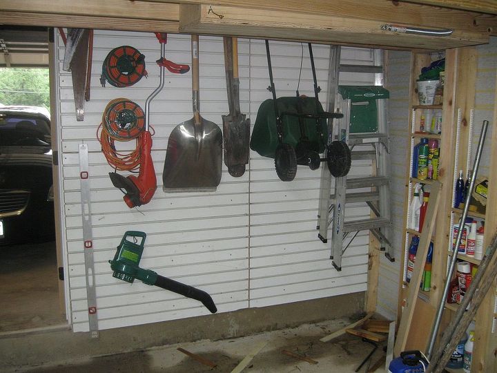 building a backyard shed shop, Slatwall panels were hung to store yard tools away