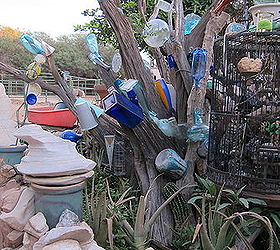 collection of glass vases and pots made into a bottle tree drought resistent, outdoor living, repurposing upcycling