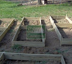 creating a raised garden bed in just a few hours, gardening, raised garden beds, Check to make sure that the exterior of planter box is below ground level by at least one inch and that the box is level and square If you are on a slope you can consider burying parts deeper or buildup the exterior