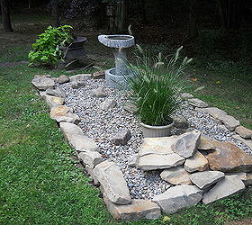 disguising the septic system, landscape, outdoor living, plumbing, Disguising the septic system Add river gravel some stone a great bird bath and wa la Easy to get to when we have to and easy to find now