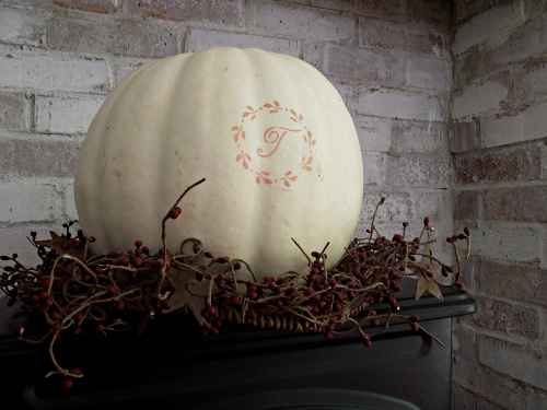 a simple yet striking mantel for fall, living room ideas, seasonal holiday decor, monogram pumpkin