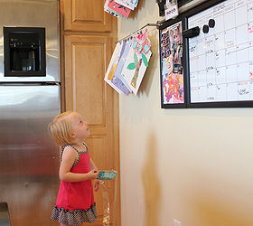 organizing children s artwork, kitchen design, organizing, Kate loves seeing all her fun art work showcased on the wall She ll often ask us to clip new projects up when she brings them home or take something down so she can play with it