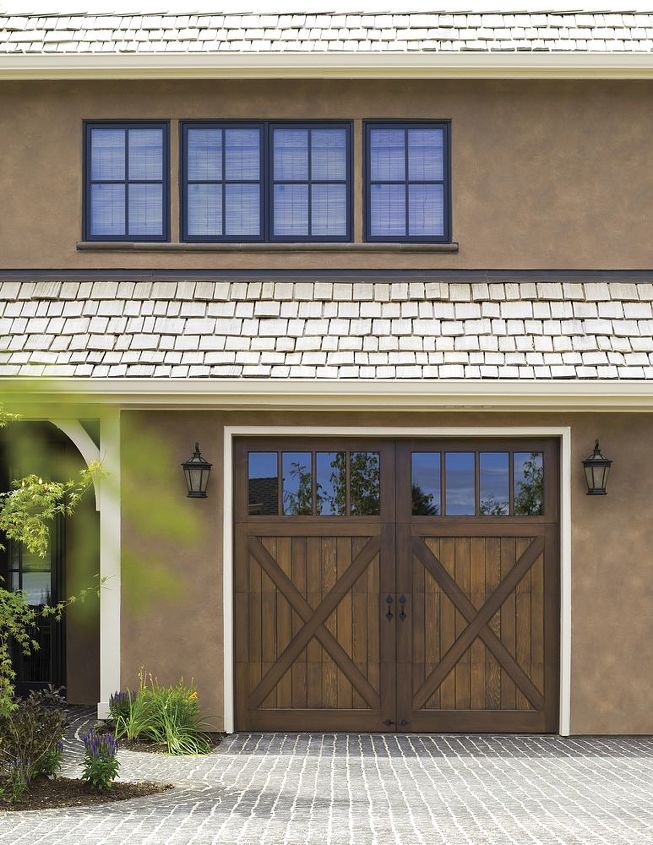 wood carriage house garage doors, Clopay Reserve Collection Custom Limited Edition insulated garage door Design 5 with REC14 windows Stained Cedar Featured in Country Home magazine