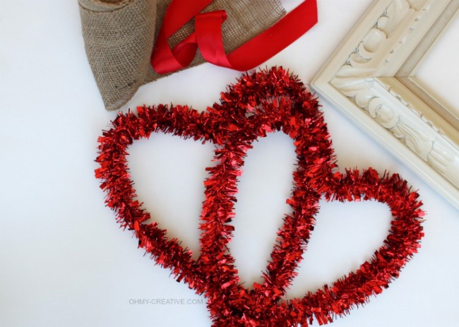 valentine heart art, crafts, seasonal holiday decor, valentines day ideas, 2 Foil Garland Hearts from Dollar Tree Wide Burlap Ribbon Red Satin Ribbon Thrift Store Frame Glue Wire Paint for Picture Frame
