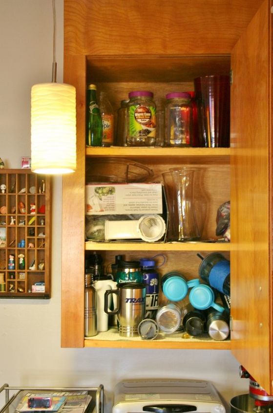 organizing kitchen cabinets with a cork message center, kitchen cabinets, kitchen design, organizing, Then there is the massive amount of water bottles vases glass containers the list goes on