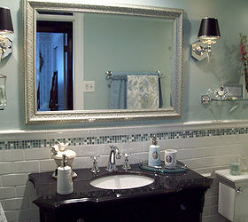 spa blue bathroom makeover on a budget, bathroom ideas, home improvement, tiling, Here is the mirror from a resale shop and I love it Perfect size color and price Continue the white subway tile from the bathtub onto the wall behind the vanity and a small line of glass accent tile