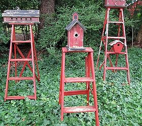 repurpose ladders into birdhouse stands, gardening, repurposing upcycling, Mount birdhouses on old ladders to create functional garden accents I painted the ladders and the birdhouses in the same barn red to make them a grouping They bring color to a shady area covered in ivy Best of all they are occupied