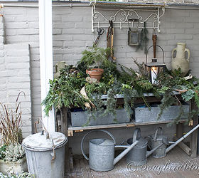 christmas outdoor decor, outdoor living, seasonal holiday decor, The garden workbench got and easy and rustic look with lots of greenery