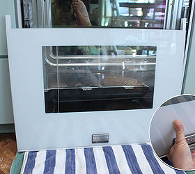 how to clean inside your oven door, appliances, cleaning tips, Keep one hand on the glass or better yet get a helper to hold the glass as you remove the two screws completely Gently lower it onto the towel