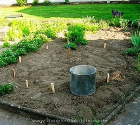 how to build a herb spiral garden, diy, flowers, gardening, homesteading, how to, perennial, Measuring the circle pond position with a string stake in the center