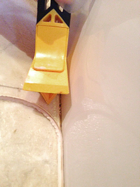 recaulk a tub in 5 easy steps plus my trick for perfect lines, bathroom ideas, home maintenance repairs, I like to use a caulk remover tool It makes getting out all the old bits of caulk much easier