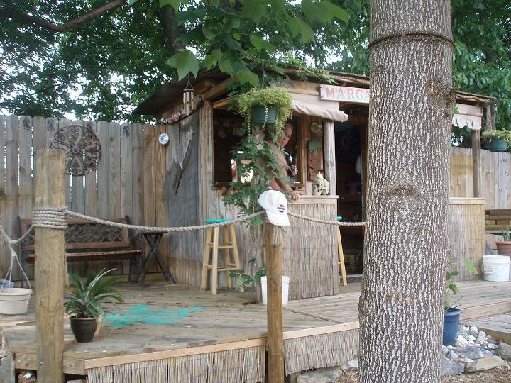 garden, outdoor living, The bar which is a 2 seater has a swing up door with slide bolts inside for security I made the doorframe from 2x4s and covered it in the same siding It has a slide bolt and padlock hasp We added more decking to gain space