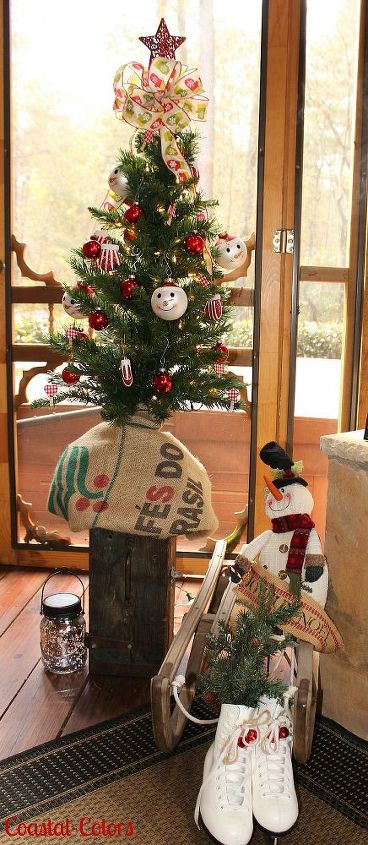 a vintage christmas on the porch, christmas decorations, outdoor living, repurposing upcycling, seasonal holiday decor, A tiny tree sits atop a vintage tool box The sled is also another vintage piece These were found at thrift stores too