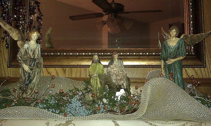 welcome to our christmas, christmas decorations, seasonal holiday decor, Some more of my favorite pieces on our mantel Angela Tripi by Roman 1988 The fresh evergreen sprigs with their blue berries go with the blue in my living area I harvest some each year from a tree at my family grave side