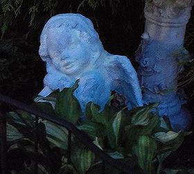 night time in the garden and patio, outdoor living, A solar spotlight from Big Lot s shines on this angel in the front yard flower bed