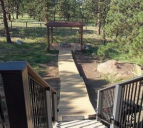 building a wooden walkway on a sloped ground any ideas, The finished product three long steps that end at a great propane firepit Thanks for all the suggestions