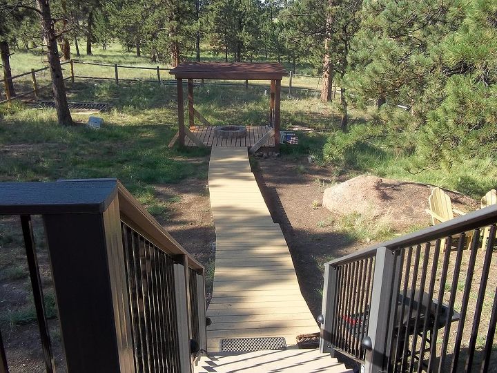 building a wooden walkway on a sloped ground any ideas, The finished product three long steps that end at a great propane firepit Thanks for all the suggestions