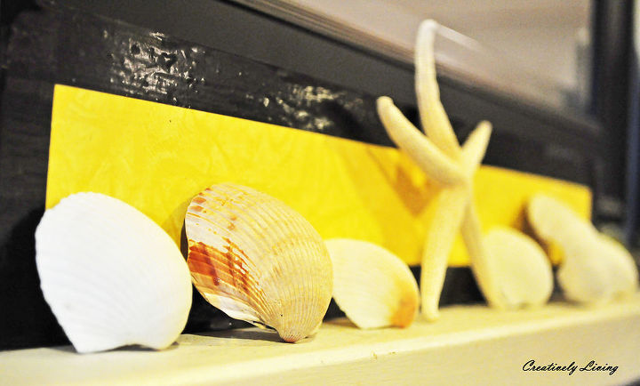 my summer mantel, electrical, fireplaces mantels, home decor, living room ideas, Check out my blog post to see how I used scrap wood electrical tape and shells we collected to make this shell display