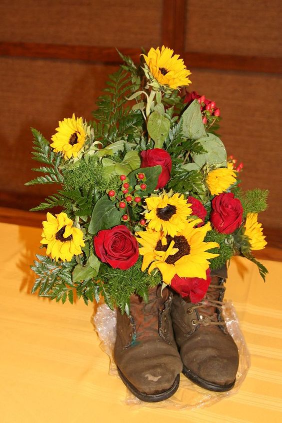 dad s boots, flowers, gardening, home decor, repurposing upcycling, With a green thumb Dad s roses were true prize winners These flowers were my tribute to very missed father I used floral foam covered with aluminum foil because I didn t want to ruin the last only pair of ud boot in existence