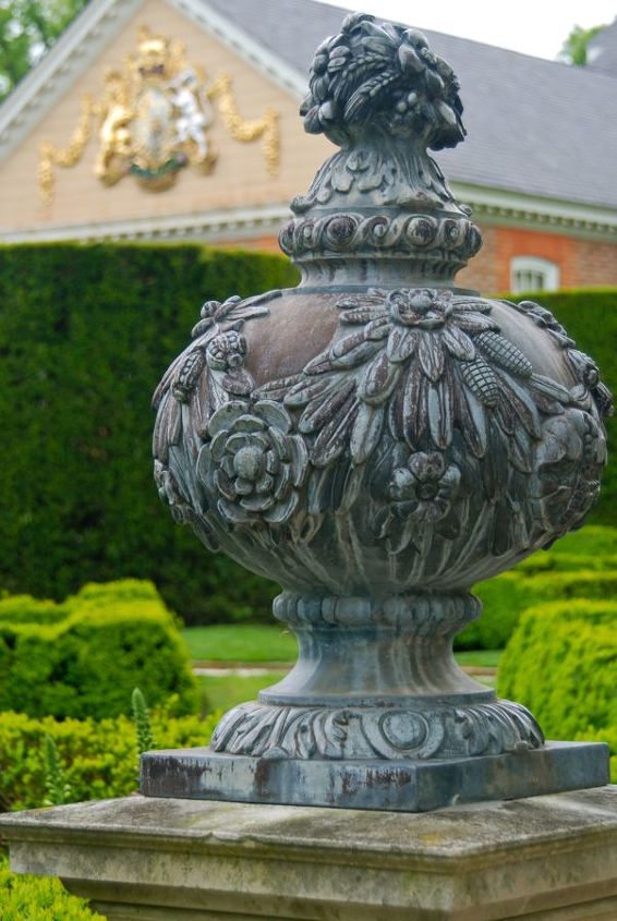 the governor s palace wall finials, gardening, and the crest of the English monarchy at the back of the palace