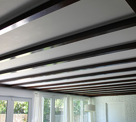 exposed beam ceiling before and after, diy, home improvement, paint colors, woodworking projects, Exposed beam ceiling reveal Dark stained beams finished and insulated in between The beams match the floors throughout the house and the white paint opens up the space even more