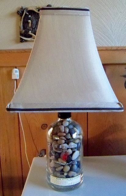 how to repupose a pendleton whiskey bottle, repurposing upcycling, Filled with polished rocks added a tan with brown trim shade Nice lamp