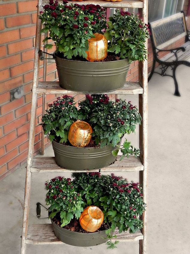 diy pumpkin watering system for mum, container gardening, gardening, porches, seasonal holiday decor, Each container get its own pumpkin watering bottle to keep it hydrated and happy