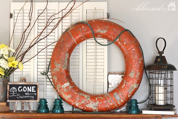 vibrant amp happy summer mantel, home decor, seasonal holiday decor, This life preserver ring was a yard sale find for 5