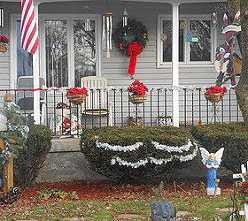 fall halloween down decked the porch with winter holiday colors, christmas decorations, decks, porches, seasonal holiday decor, wreaths, Add a wreath to sled pete had hung the wooden skis snow man deco up in the tree Added more light to the wreath from last year