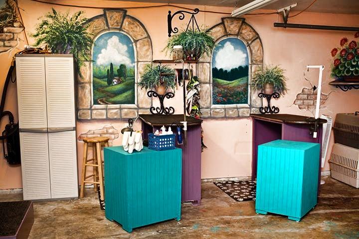 pretty pet parlor vs ugly mugly garage, garage doors, home improvement, pets animals, Fun colorful murals I painted with Behr exterior paint and inexpensive tables I built with 2x2 and paneling from Home Depot make this garage a much more inviting