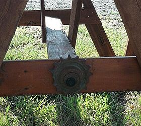 child s pallet and recycled cedar fencing picnic table, diy, outdoor furniture, outdoor living, painted furniture, pallet, woodworking projects, Found this old John Deere gears at a friends pasture to give it the decorative edge I like