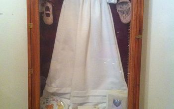 My husband built my daughter a shadow box to hold her baptism dress