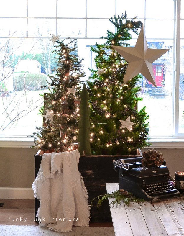a christmas tree forest in a crate, seasonal holiday d cor, Slightly bending the tops to the sides added an unexpected whimsical take A star theme came into play with music sheet stars and one big guy just for fun