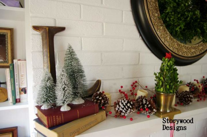 a holly jolly mantel, crafts, seasonal holiday decor, wreaths, Inexpensive bottle brush trees from Walmart flank our initial and sit atop stacked books