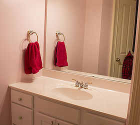 half bathroom reveal, bathroom ideas, home decor, This is the before pink walls white cabinets huge mirror on the wall