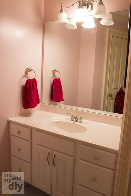 This is the before...pink walls, white cabinets, huge mirror on the wall.