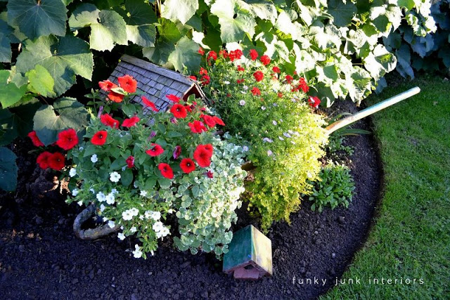 how to grow your garden with junk, flowers, gardening, outdoor living, repurposing upcycling, You d never know there was a crusty old wheelbarrow underneath these blooms gone wild