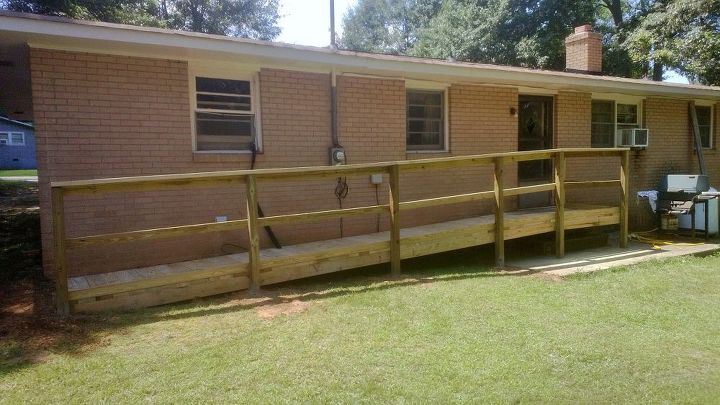 this is one ramp built by our brotherhood for one of our elder members, curb appeal, diy, woodworking projects, The middle rail is a 2x4 and there is a 4 toe kick at the bottom the slope is 1 per foot drop